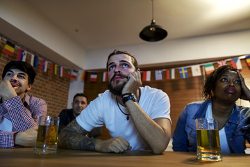 Friends cheering sport at bar together