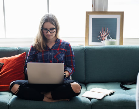 Caucasian Woman Using Computer Laptop On The Couch