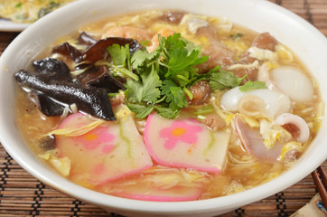 The mixed thick noodle soup - boiled noodles with fungus. sliced pork. egg