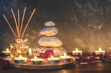 Spa composition-stones, candles, aromatherapy, dry flowers.