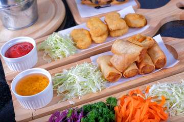 Fried Chinese spring rolls and chicken nuggets
