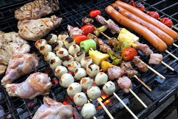Low cost meat and sausages barbecue and grilled sweet potatoes