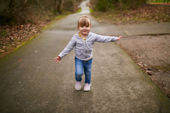 Young Girl Running Towards Camera