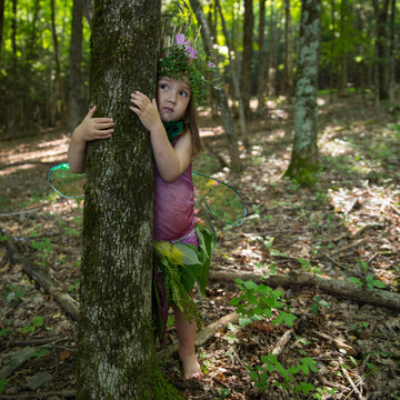 Little Girl Dressed as Fairy, Hiding in the Forest