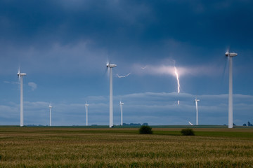 Wind turbines with a lightning bolt on the background - 197292338