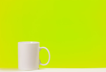 Cup white coffee on colored background with space for text