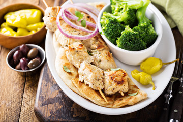 Grilled chicken kebabs on a pita