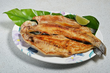 Pan fried trout with  lemon on plate