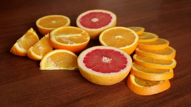 Sliced citrus fruits, oranges and grapefruit, on wooden table, close-up. Abstract background with citrus-fruit of orange slices. Close-up. Sliced orange background.