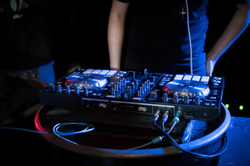 Fototapeta na wymiar DJ playing turntable music on night club party