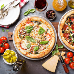 Margherita and pepperoni pizza with basil