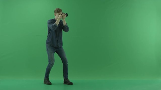 Photographer taking photos on the right hand side around myself on the green screen