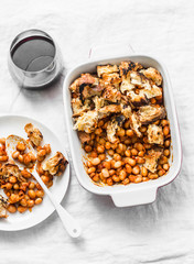 British baked tomato sauce bean and bacon with bread crumbs and glass of red vine on light background, top view. Flat lay