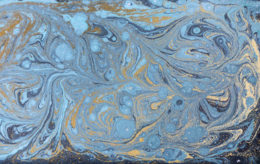 Marble abstract acrylic background. Nature blue marbling artwork texture. Gold glitter.
