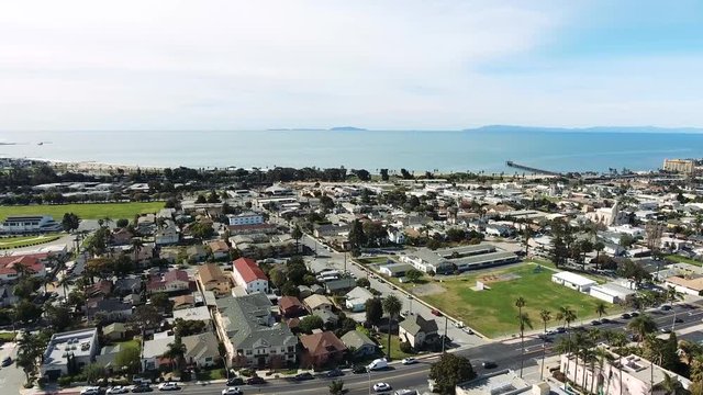 Aerial Flyover Panning Seaward - Southern California coastal town with islands in the distance
