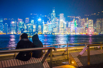 Tourists relaxing around Victoria Harbor at night time in Hong Kong