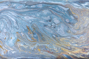 Marble abstract acrylic background. Nature blue marbling artwork texture. Gold glitter.