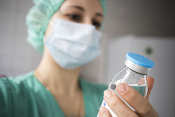 woman doctor with a gauze bandage holds the medicine in hand