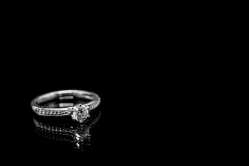 Close up Jewelry diamond ring on black background with reflection