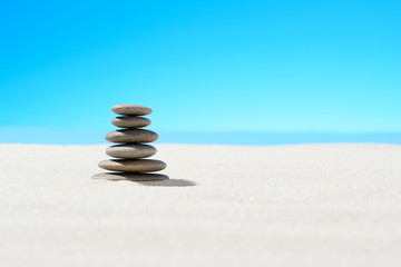 Fototapeta na wymiar Zen stones on the sandy beach