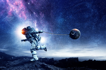 Fantasy image with spaceman catch planet. Mixed media