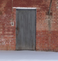 Wooden door in a brick wall.