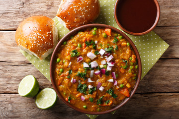 Pav Bhaji Indian spicy fast food with bread Paav close-up on the table. horizontal top view