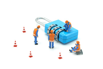 Miniature people Construction worker Security Key Repair And the treatment of the precious. on white background using as background business concept and Security concept with copy space.