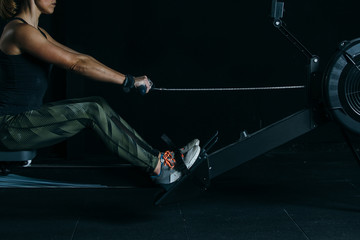 Young woman doing rowing exercise