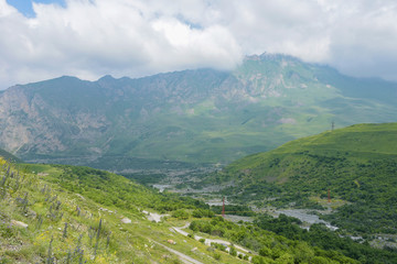Fototapeta na wymiar The Karmadon (Genaldon) Gorge summer view. North Ossetia, Russia. The Caucasus Mountains.