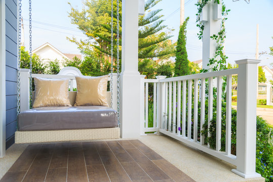 A modern swing at a balcony with nature background.