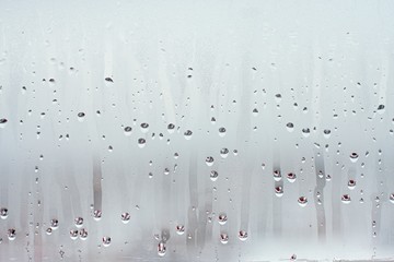 Water droplets condensation background of dew on glass window, humidity and foggy blank background....