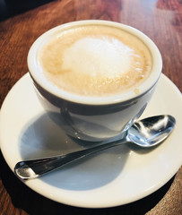 Cup of cappuccino served on table