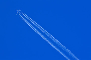 Flying aeroplane with leaving white trails