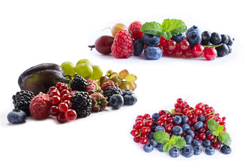 Set of fresh fruits and berries. Ripe blueberries, blackberries, red currants, grapes, raspberries and plums. Various fresh summer berries on white background. 