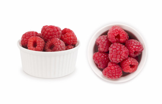Set of red raspberries. Raspberries in a bowl isolated on white background. Vegetarian or healthy eating. Raspberry with copy space for text.