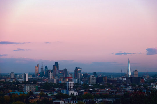 View towards London city skyline at sunset from parliament hill in Hampstead Heath