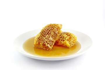 Fresh honey with honeycomb on a white background