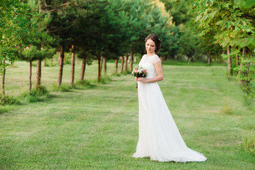 The bride holding bouquet of flowers. Wedding