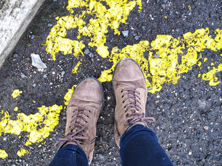 Shoes on a yellow road markings