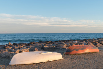 two boats stranded on the beach sand