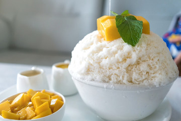Bingsu mango (Korean Desserts) Shaved ice desserts with mango on top and sweetened condensed milk and condensed mango juice.