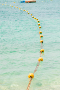 Yellow Safety buoys drifting in the Sea to keep swimmers away from dangerous.