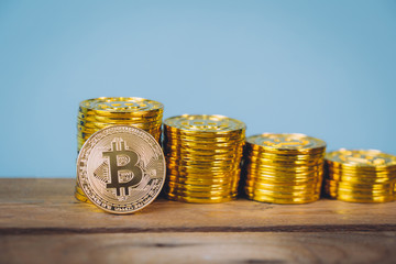 Bitcoin coins stack over blue pastel background with copy space. Digital money saving and cryptocurrency concept