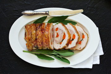 Fried pork loin stuffed with carrots and garlic. Festive dish.