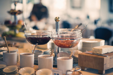 Fresh and bright continental breakfast table with jam. Table settings