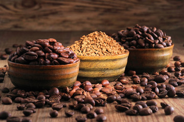 Coffee beans pile and coffe instant on the background of ground coffee