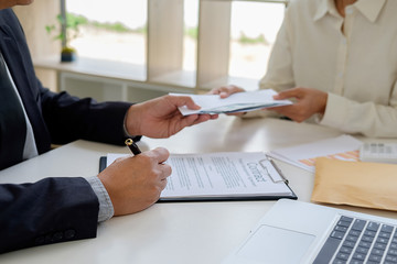 Businessman giving money while making deal to agreement a real estate contract and financial corporate.Bribe and corruption concept