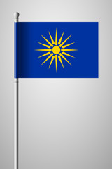 Fototapeta premium The Vergina Sun. Macedonian Flag Unofficial Version. National Flag on Flagpole. Isolated Illustration on Gray
