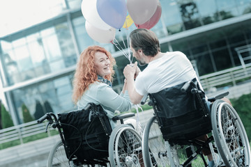 Need your help. Delighted couple looking at each other and having pleasant conversation while being...